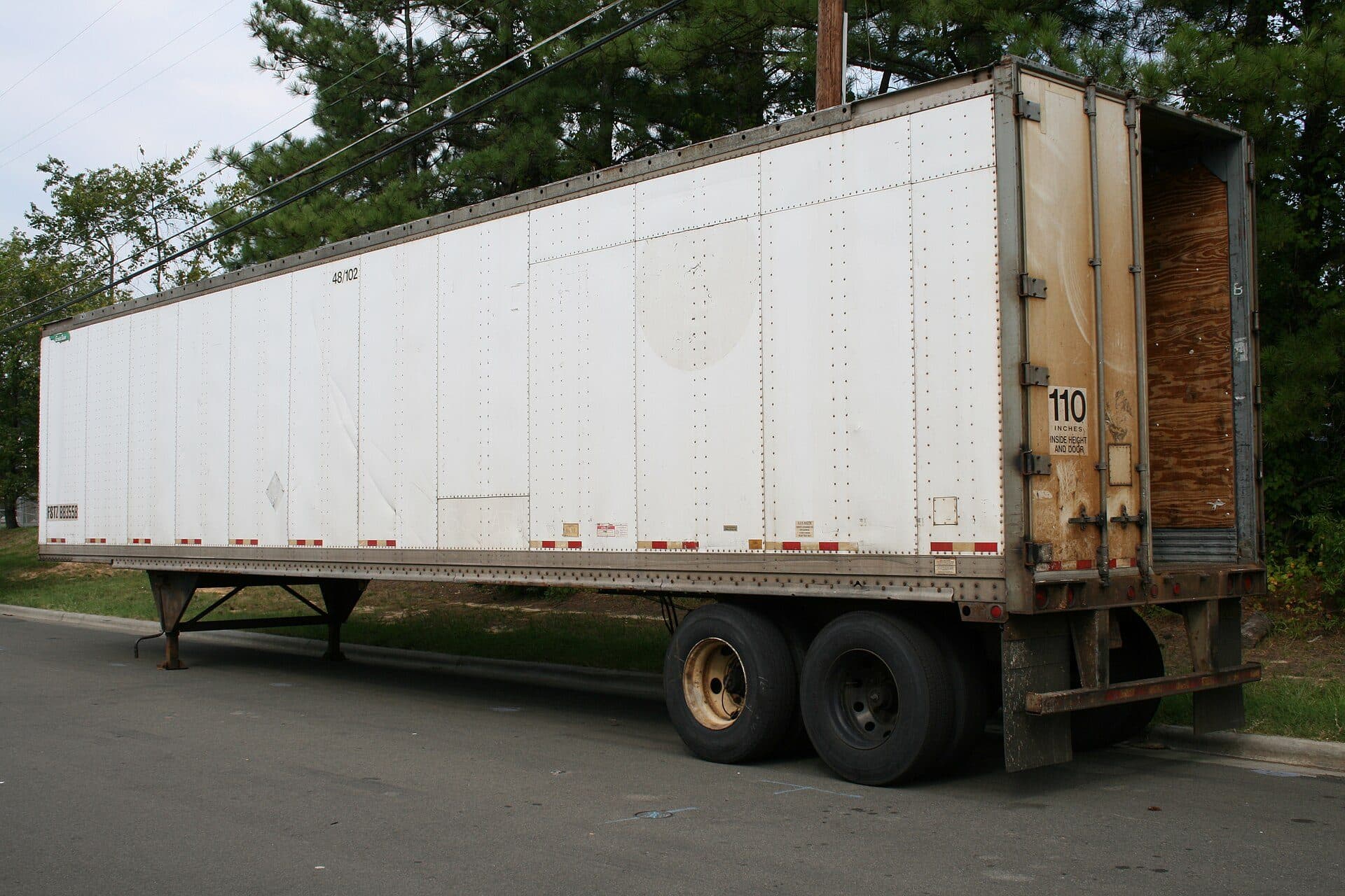 Dry van trailer parked with its rear doors open